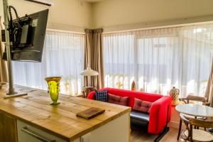 uma sala de estar com um sofá vermelho e uma mesa em B&B Amsterdam De Springer em Amsterdã
