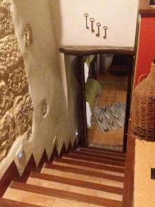 a spiral staircase with a mirror in a room at La Casa del Pittore di Petralia in Petralia Soprana