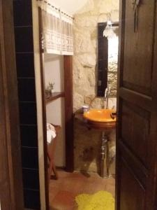 a bathroom with a sink and a toilet and a mirror at La Casa del Pittore di Petralia in Petralia Soprana