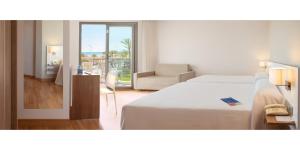 a hotel room with a bed and a living room at RH Bayren Hotel & Spa 4* Sup in Gandía