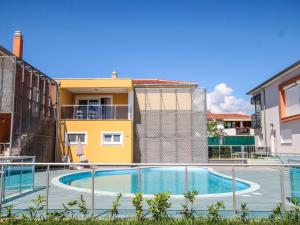 a swimming pool in front of a building at Apartment in Funtana with Three-Bedrooms 1 in Funtana