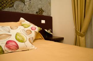 a bedroom with a bed with a pillow on it at B&B Sosta Flegrea in Naples
