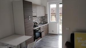 a kitchen with wooden cabinets and a stove top oven at Novantatrè in Campobasso