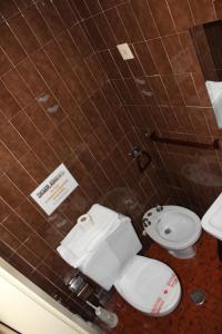 a bathroom with a toilet and a sink at Hostal Andalucia in Almuñécar