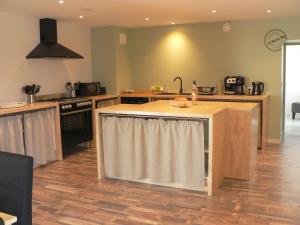 a kitchen with an island in the middle of it at LE VAL DE RY in Les Herbiers
