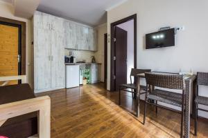 a living room with a table and chairs and a kitchen at 2 Room Cozy Apartment in Bakuriani in Bakuriani