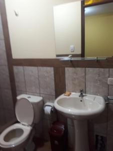 a bathroom with a toilet and a sink at El Marquez in Tacna