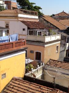 a view of roofs of buildings with a balcony at Lapa Chêca Guest House in Rio de Janeiro