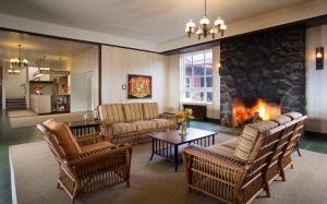 a living room with couches and a fireplace at Volcano House in Volcano