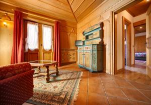 a living room with a stove and a couch and a table at Hotel Natale in Cortina dʼAmpezzo