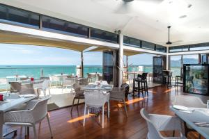 a restaurant with a view of the ocean at Ramada Suites by Wyndham Wailoaloa Beach Fiji in Nadi