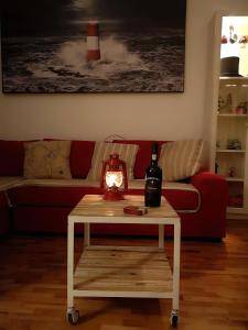 a living room with a table with a bottle of wine at Il Pirata Innamorato in Lido di Ostia
