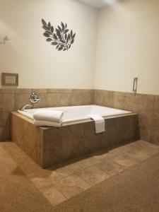 a bath tub with two towels sitting on top of it at Grand View Inn & Suites in Wasilla