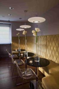 a dining room table with two chairs and two lamps at Soleil Boutique H in Sopot