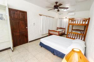 Postel nebo postele na pokoji v ubytování Hotel Flor Blanca