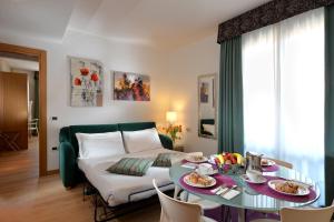 a room with a bed and a table with food on it at Elite Hotel & Spa in Mestre