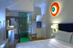 a bedroom with a bed and a glass shower at Elite Hotel & Spa in Mestre