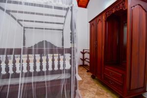 Ένα ή περισσότερα κρεβάτια σε δωμάτιο στο Simon's Lodge Hikkaduwa