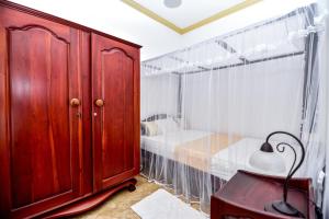 Ένα ή περισσότερα κρεβάτια σε δωμάτιο στο Simon's Lodge Hikkaduwa