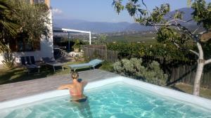a person is standing in a swimming pool at Heideggerhof in Bolzano +6 photos