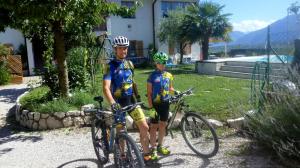 a man and a boy standing next to their bikes at Heideggerhof in Bolzano