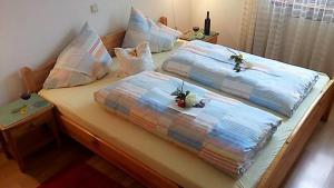 a bed with two pillows on top of it at Heideggerhof in Bolzano
