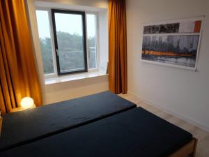 a bedroom with a bed and a window at Ferienwohnung Albatros in Binz