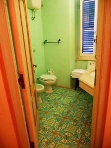 a bathroom with a toilet and a sink at Locanda di Porta Antica in San Benedetto del Tronto +14 photos