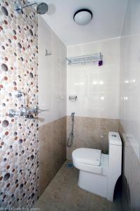 biała łazienka z toaletą i prysznicem w obiekcie Yeti Inn Pvt. Ltd. w Katmandu