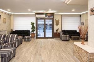 a lobby with couches and chairs and a door at Hotel ANDINO in Encamp