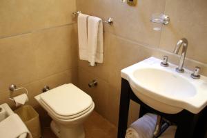 a bathroom with a toilet and a sink at Prince Hotel in Mar del Plata
