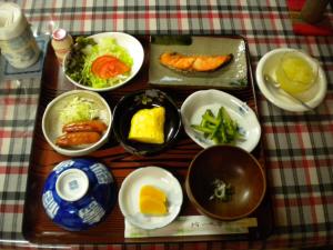 a table with plates of food on a table at Mimatsuso Ryokan in Asahikawa