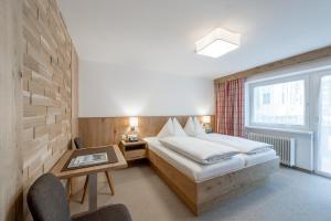 ein Hotelzimmer mit einem Bett und einem Fenster in der Unterkunft Pension Michael in Obergurgl