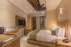Ένα ή περισσότερα κρεβάτια σε δωμάτιο στο Samann Grand