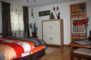 a bedroom with a bed and a white cabinet at Ferienwohnung Fam. Höhn in Kappel-Grafenhausen