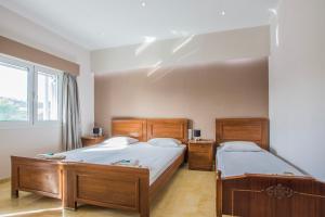 a bedroom with two beds and a window at Dennis Tsilivi Houses & Studios by "elite" in Tsilivi