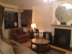 a living room with a couch and a fireplace at Ardmullen in Kenmare