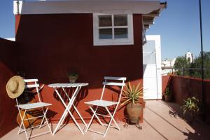 a patio with chairs and a table on a balcony at Silves Historical House in Silves +16 photos