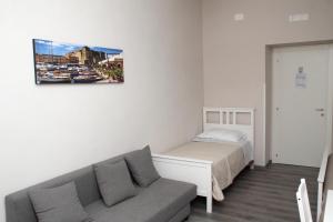 a living room with a bed and a couch at B&B Materdei 14 in Naples