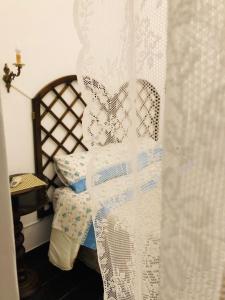 a bedroom with a bed with a white curtain at A Casa di Claudia in Naples