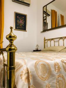 a bedroom with a bed and a mirror on the wall at A Casa di Claudia in Naples