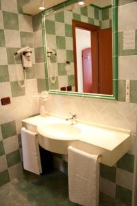 a bathroom with a sink and a mirror at Hotel Felix in Scalea