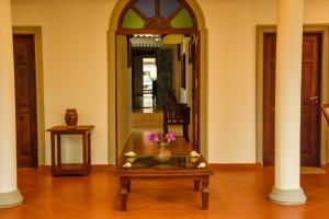 a living room with a table and a mirror at Oriental Rest in Hikkaduwa