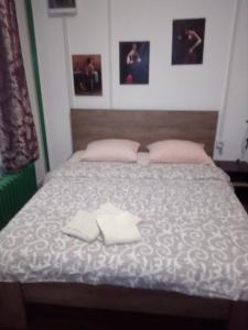 a bedroom with a bed with two towels on it at Apartment Viktor stan na dan in Šabac