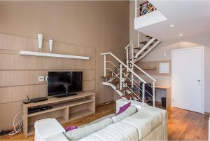 - un salon avec un canapé blanc et un escalier dans l'établissement Duplex NYC Berrini 2 dormitórios - ao lado do WTC, à São Paulo