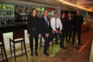 a group of people posing for a picture in a bar at Hostal Macami in Pedro Abad