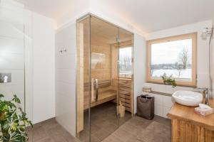 łazienka z przeszkloną kabiną prysznicową i umywalką w obiekcie Naturchalet Höflehner - Heimgefühl & Ruhelage an Loipe & Wanderweg w mieście Ramsau am Dachstein +37 zdjęć