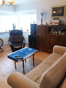 a living room with a couch and a coffee table at Midhop guesthouse in Þingeyrar