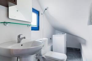 a white bathroom with a sink and a toilet at Lianas Garden House in Rhodes Town +19 photos