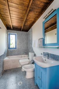 a bathroom with a sink and a toilet and a tub at Lianas Garden House in Rhodes Town